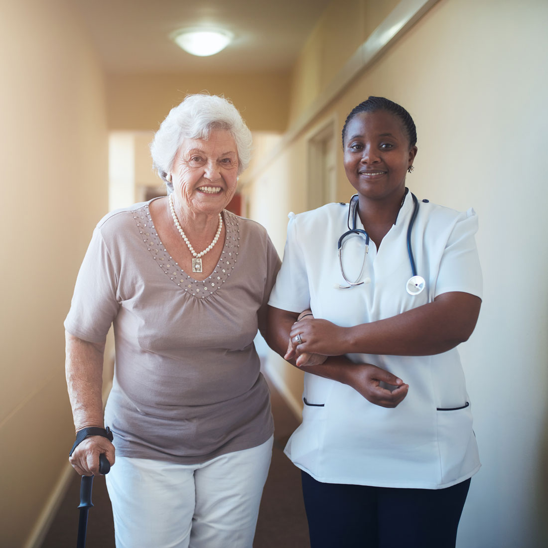 nurse-assisting-a-senior-patient-to-walk-PFMB22A